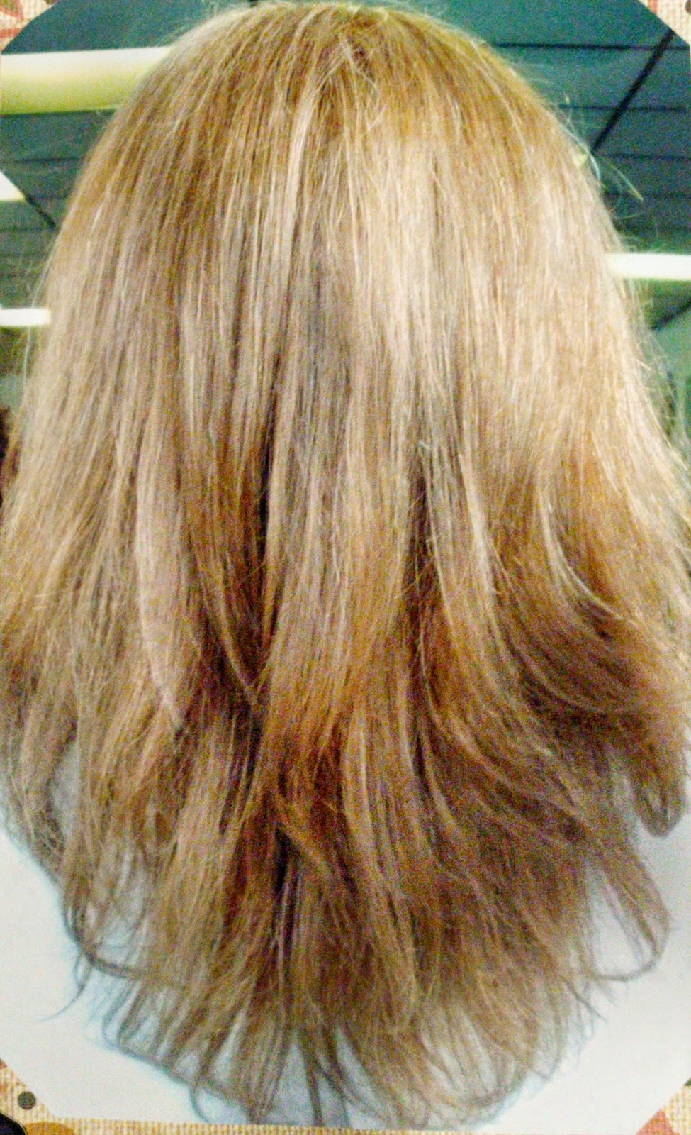 Blonde and caramel layered cut, blow-dried with flicked ends