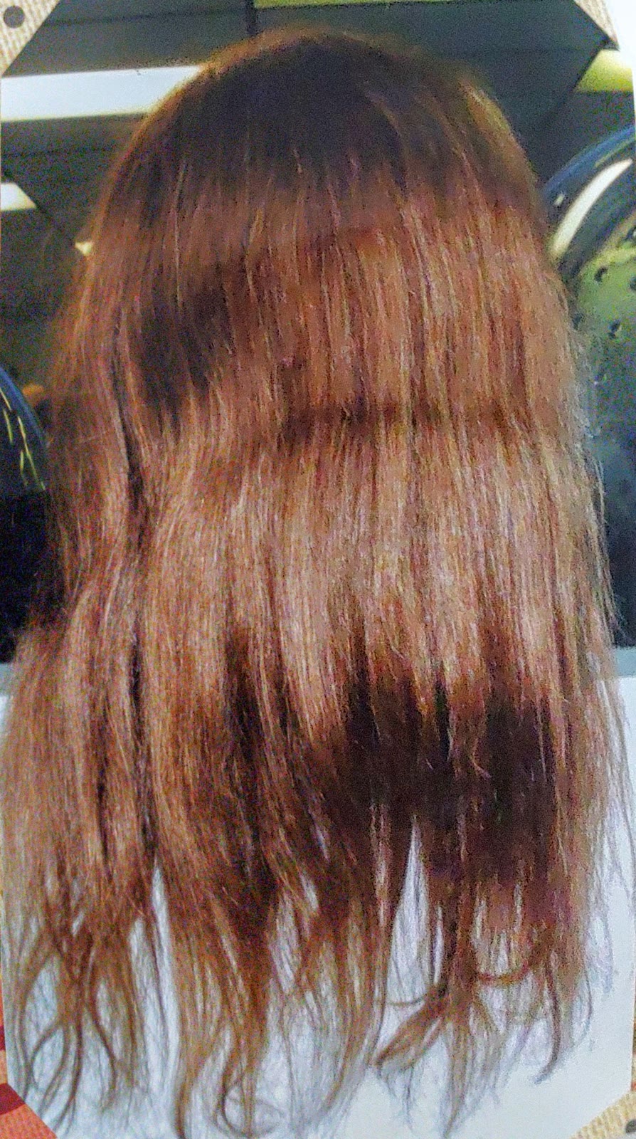 Long copper-red hair cut into soft layers
