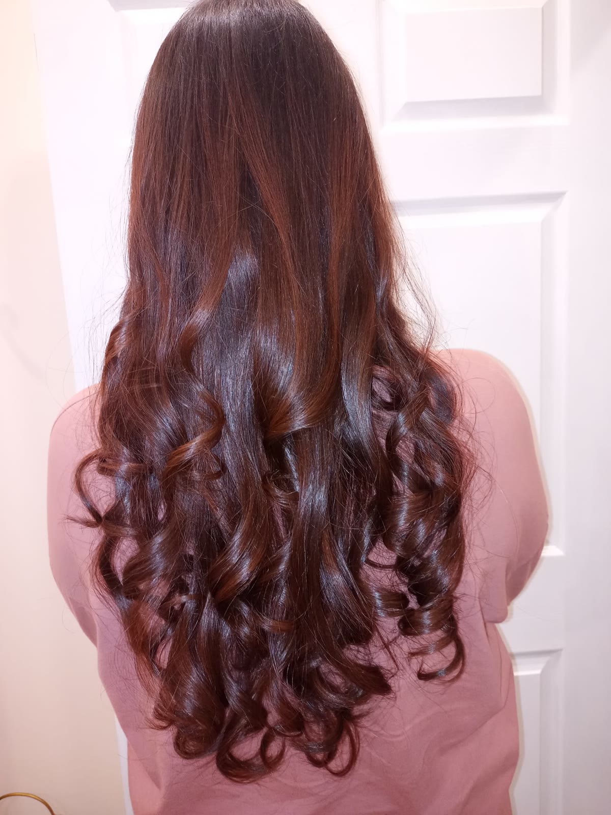 Red and violet highlights through dark hair